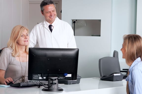 Practice owner reviewing a candidate's background when hiring